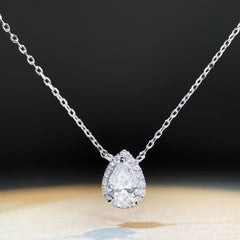 Diamond necklace with a teardrop-shaped pendant on a dark background