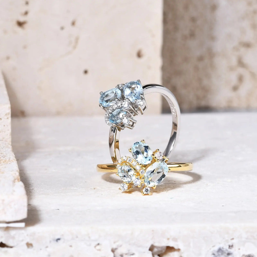 Close-up prong-set blue topaz gemstone cluster on polished gold band