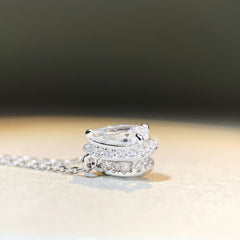 Sterling silver chain with pear-shaped Moissanite pendant, 1ct center stone with halo design.