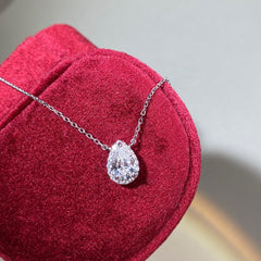 Sterling silver chain with pear-shaped Moissanite pendant, 1ct center stone with halo design.