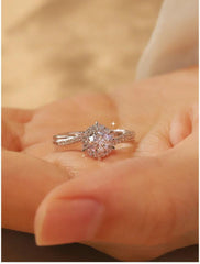 Elegant moissanite proposal ring in sterling silver with halo design"