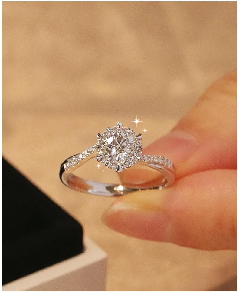 Elegant moissanite proposal ring in sterling silver with halo design"