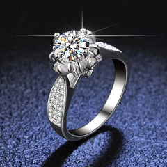 Floral-inspired 6-prong sterling silver engagement ring with lab-created round moissanite and pavé stones