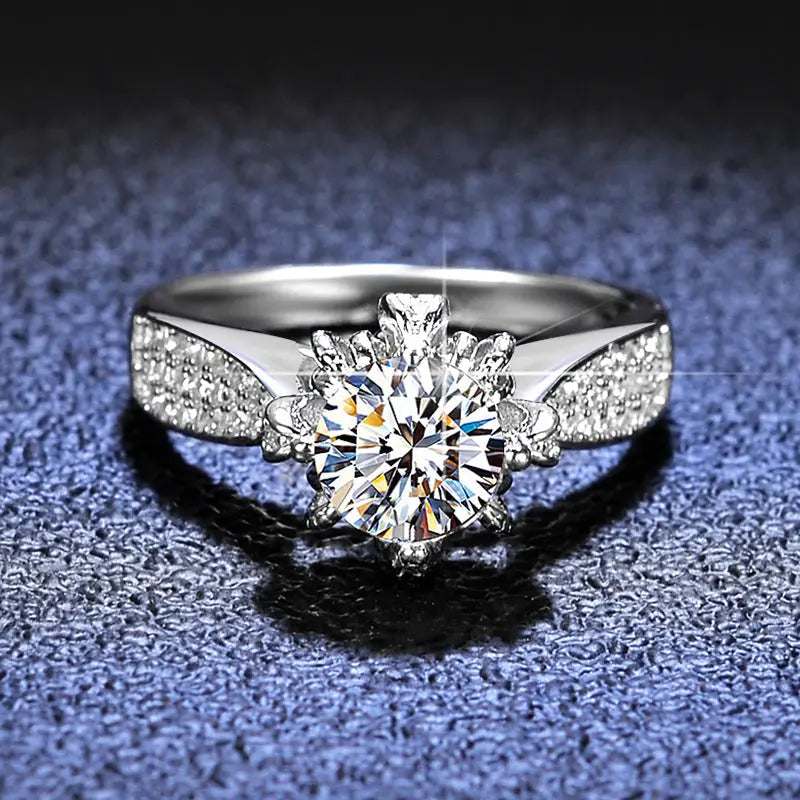 Floral-inspired 6-prong sterling silver engagement ring with round lab-created moissanite and pavé stones on band
