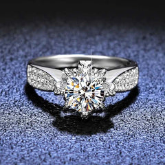 Floral-inspired 6-prong sterling silver engagement ring with round lab-created moissanite and pavé stones on band