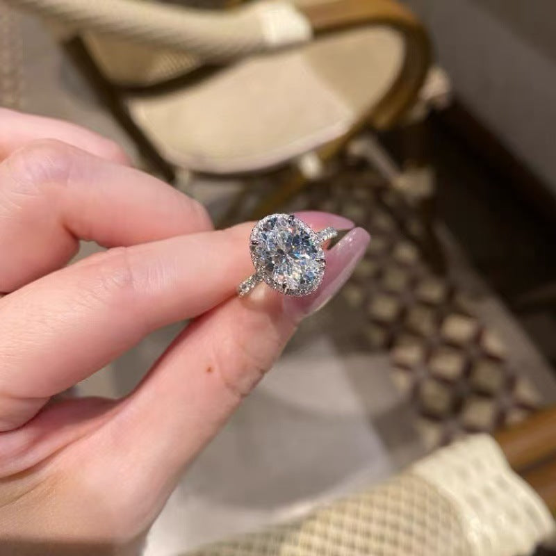 5ct oval halo moissanite statement ring with pavé band on white background