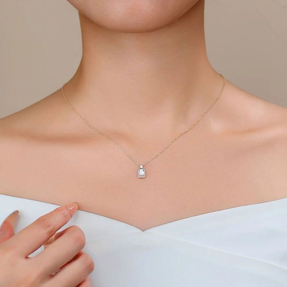 Model wearing 14K gold 0.50ct emerald-cut halo lab-grown diamond pendant necklace