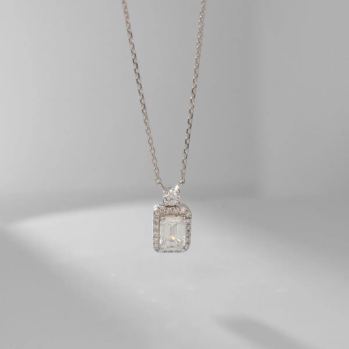 White-gold emerald-cut halo lab-grown diamond pendant on fine cable chain