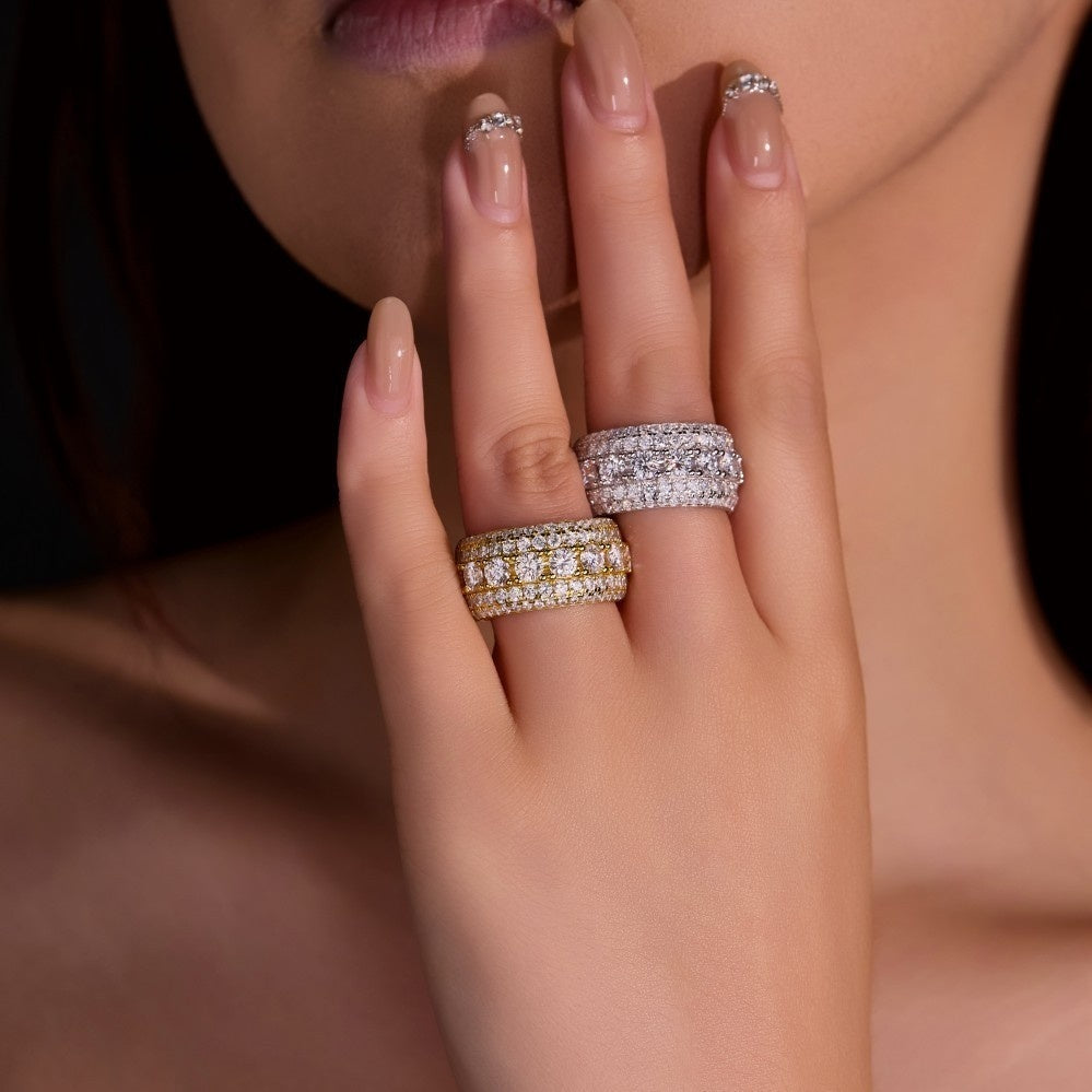 Gold pavé moissanite-inspired wide band ring with vintage statement design on black background