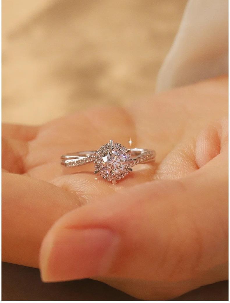 Elegant moissanite proposal ring in sterling silver with halo design"