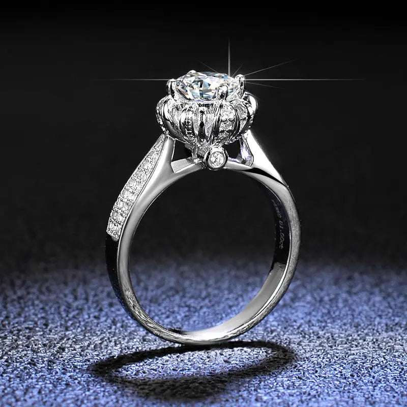 Floral-inspired 6-prong sterling silver engagement ring with lab-created round moissanite center and pavé-set stones on the band